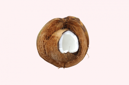 cut coconut on pink background