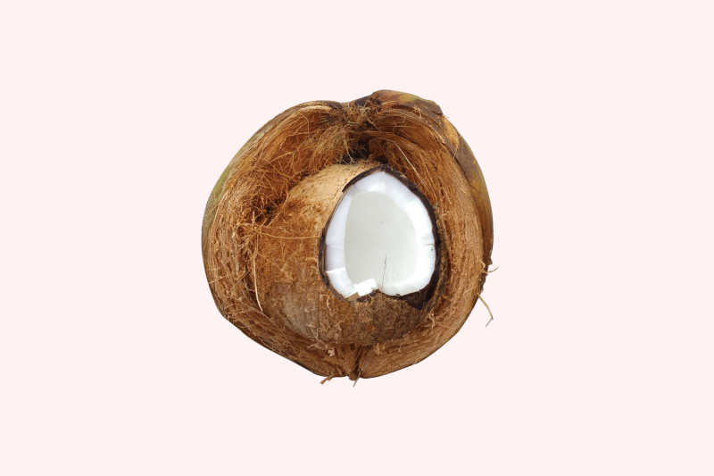 cut coconut on pink background