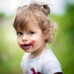 Child with messy face from food