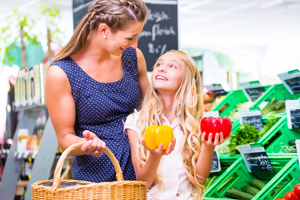 Mother and daughter buying healthy food in the supermarket