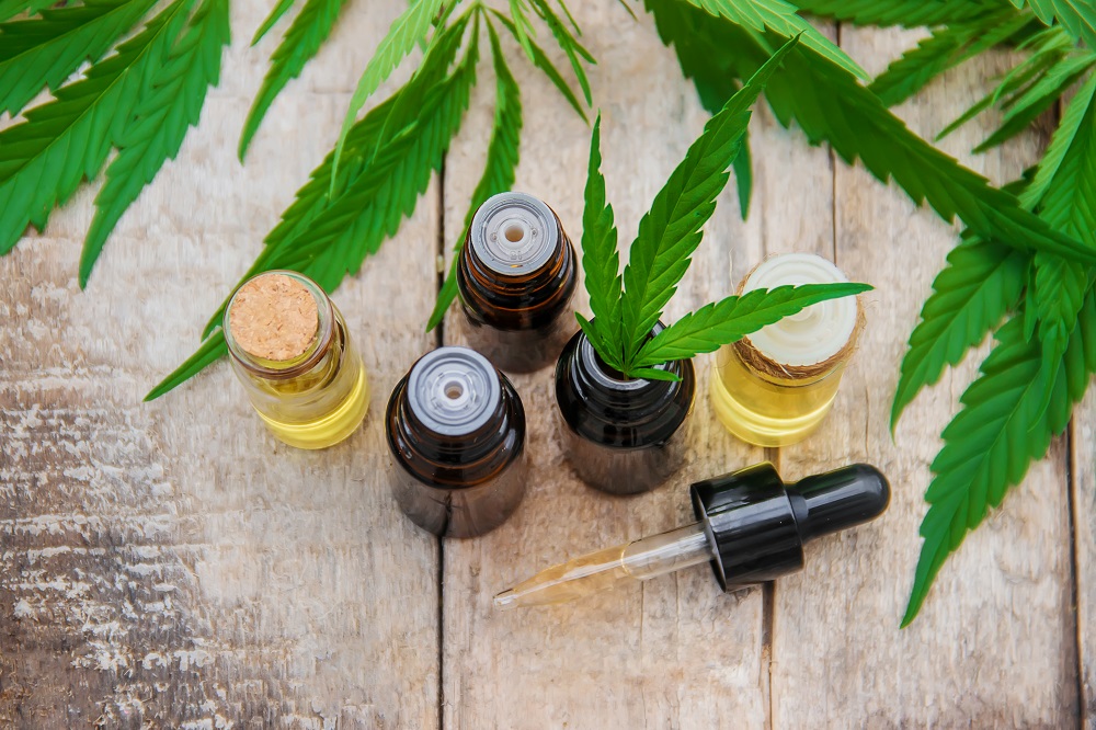 CBD oil in tincture bottles on wooden background