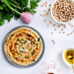 A bowl of hummus on white background