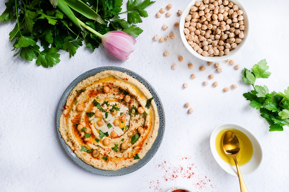 A bowl of hummus on white background